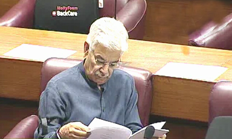 PML-N parliamentary leader in the National Assembly Khawaja Asif reads a document during the National Assembly budget session. — DawnNewsTV screengrab
