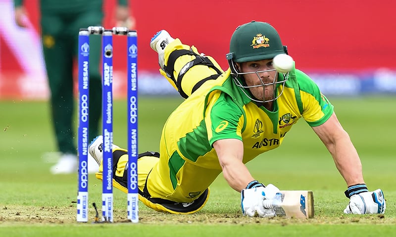 Australia's captain Aaron Finch dives to make his ground as the ball passes the stumps during the 2019 Cricket World Cup group stage match between Australia and Pakistan at The County Ground in Taunton. ─ AFP