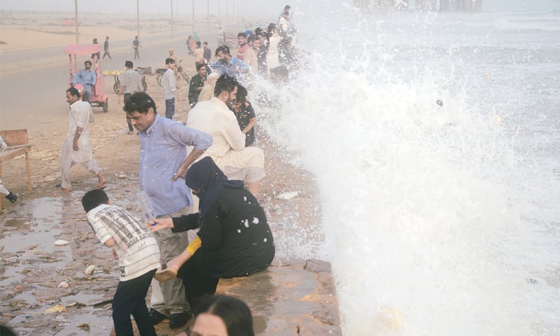 PEOPLE cool off at Seaview on Thursday, unmindful of the high waves and rough seas.&mdash;Shakil Adil / White Star
