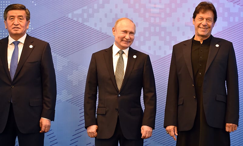 From L: Kyrgyz President Sooronbai Jeenbekov, Russian President Vladimir Putin and Prime Minister Imran Khan pose for a photo prior to a meeting of the Shanghai Cooperation Organisation Council of Heads of State in Bishkek. — AFP