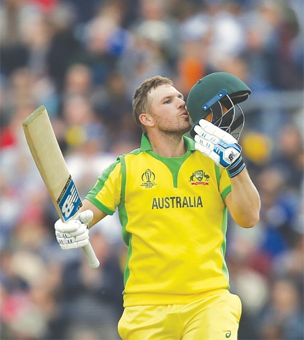 Australia captain Aaron Finch kisses the helmet after reaching his century.—AFP