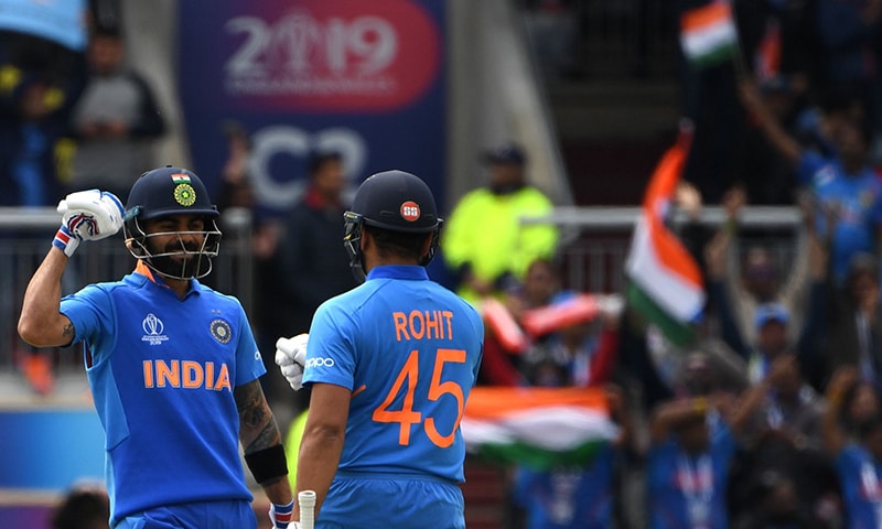 India's captain Virat Kohli (L) celebrates with teammate Rohit Sharma after the innings passed 150 during the 2019 Cricket World Cup group stage match between India and Pakistan. — AFP