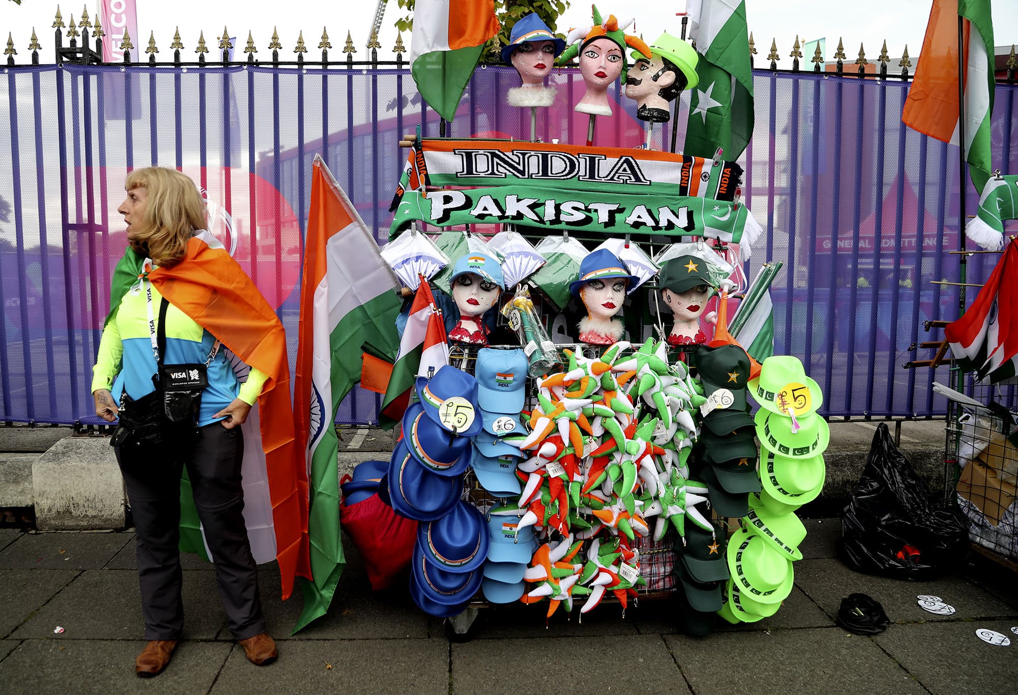 A street vendor sells Indian and Pakistani souvenirs before the match begins ─ AP