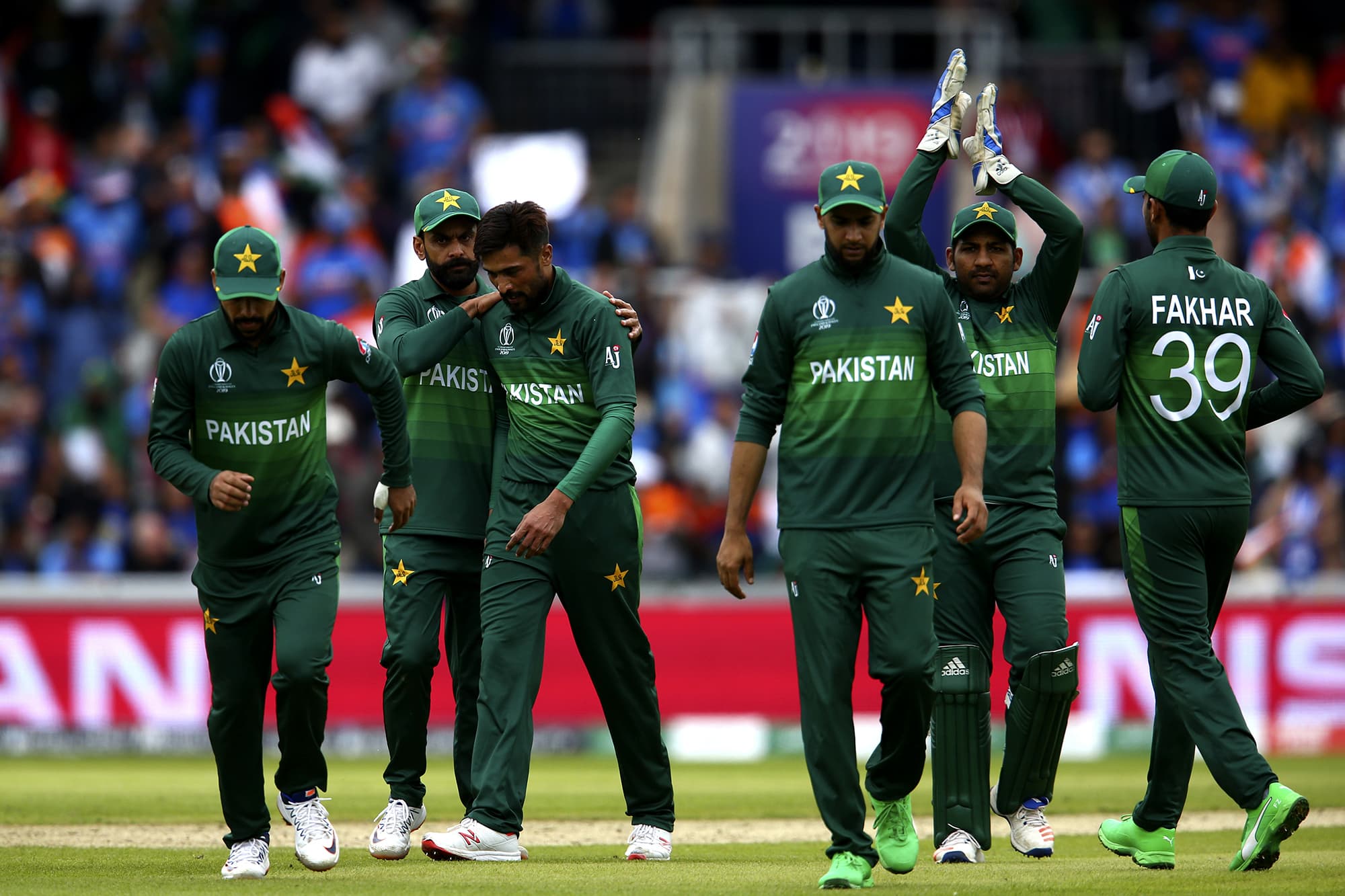 Babar Azam is congratulated by his teammates for taking the wicket of Hardik Pandya. ─ AP