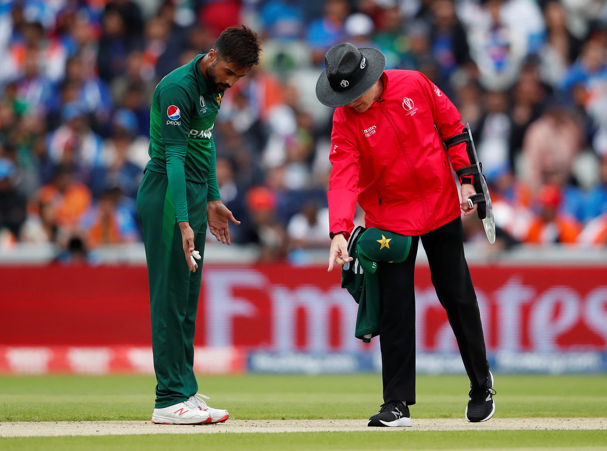 The umpire talks to Mohammad Amir about the crease. ─ Reuters