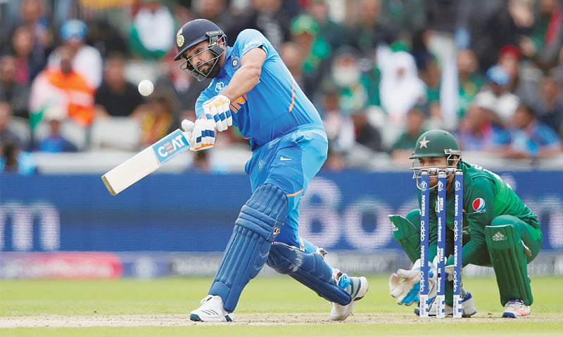 MANCHESTER: Indian opener Rohit Sharma hits over the top on his way to 140 as Pakistan captain Sarfraz Ahmed looks on during the World Cup match at Old Trafford on Sunday.—Reuters