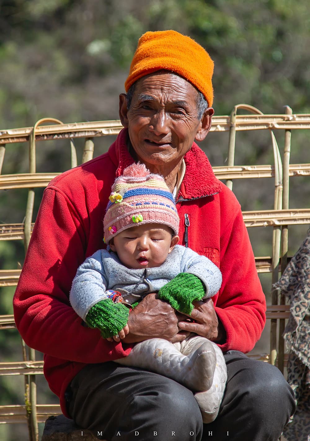 A Sherpa and his grandson soak in the sunlight on a cold day at Thangyam.