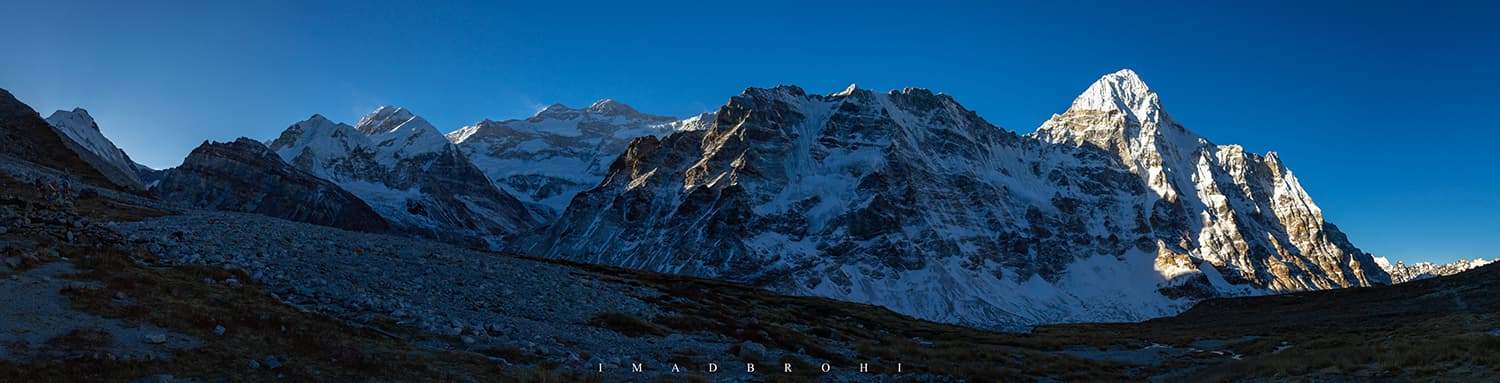 Panorama of Kangchenjunga Massif at sunrise. L-R: Nepal Peak (7,177m), Cocks Comb (black rock approximately 5,925m), Taple Shikar (6,447m), Gimmigela Chuli (also called The Twins, 7,350m), Kangchenjunga Main (8,586m), Kangchenjunga South (8,476m) and Wedge Peak (6,802m).