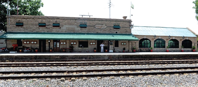 Over a century-old Golra railway station built from grey stone blocks.