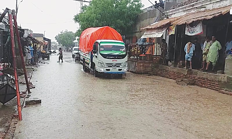A COMMERCIAL street in Kaloi town submerged in rainwater on Tuesday as widespread rains lash Tharparkar for a third consecutive day.&mdash;Dawn
