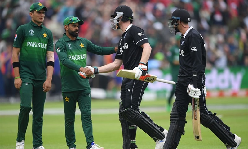 Mohammad Hafeez shakes James Neesham's hand after New Zealand wrapped their innings. — Cricket World Cup Twitter account