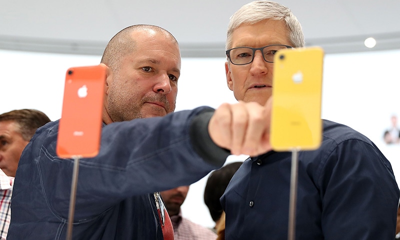 In this file photo taken on September 12, 2018 Apple chief design officer Jony Ive (L) and Apple CEO Tim Cook inspect the  iPhone XR during an Apple special event at the Steve Jobs Theatre  in Cupertino, California. &mdash; AFP