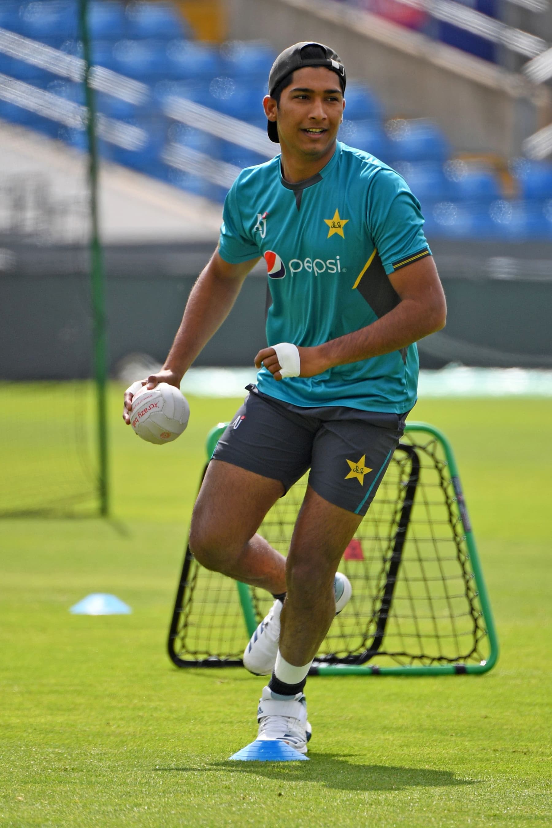 Mohammad Hasnain takes hold of the ball during the team training session at Headingly. — AFP