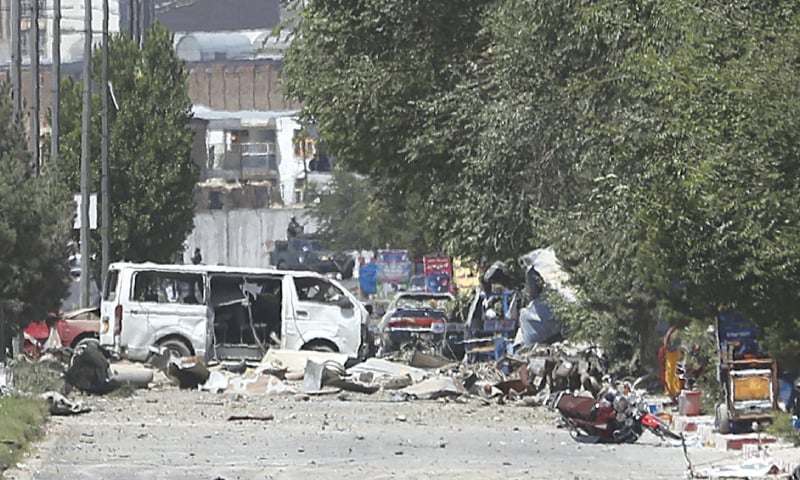 DESTROYED vehicles sit at the site of an explosion in Kabul on Monday. — AP