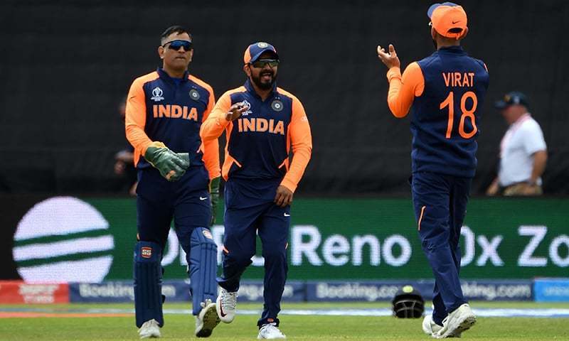 India's captain Virat Kohli (R) celebrates with teammates Kedar Jadhav (C) and Mahendra Singh Dhoni (L) after the dismissal of England's captain Eoin Morgan during the 2019 World Cup group stage match between England and India at Edgbaston in Birmingham, central England, on June 30. — AFP/File