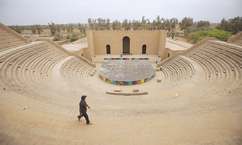 A man walks in front of the Ishtar Gate at the ancient archaeological site of Babylon, Iraq.—AP