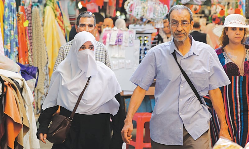 A woman wearing niqab walks in the old city of Tunis.&mdash;Reuters