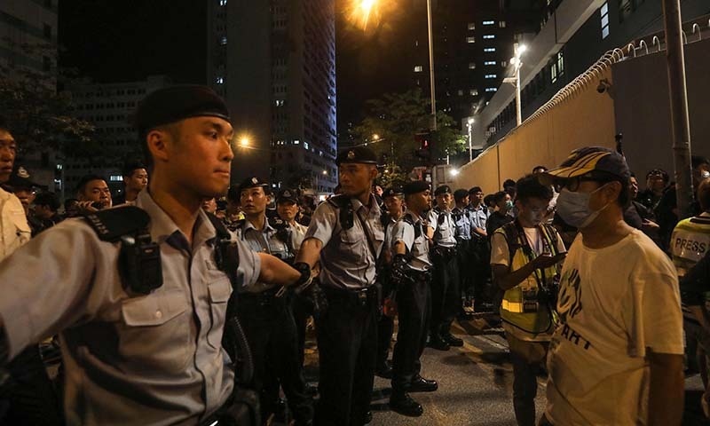 Policemen hold hands to line up and surround protesters during a demonstration in the north-western district of Tuen Mun, near the border with the Chinese city of Shenzhen, in Hong Kong on July 6. — AFP Policemen hold hands to line up and surround protesters during a demonstration in the north-western district of Tuen Mun, near the border with the Chinese city of Shenzhen, in Hong Kong on July 6. — AFP