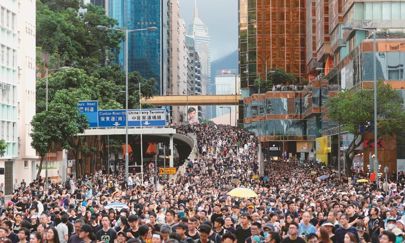 HONG KONG: Protesters march to a train station in this city’s tourism district.—Reuters