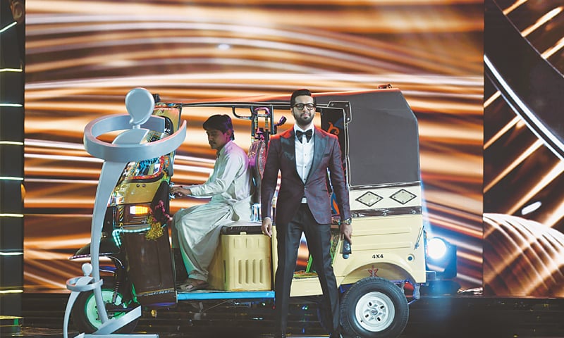 ONE of the hosts, Fahad Mustafa, makes his entrance in an auto rickshaw on stage during the ceremony held at the Expo Centre on Sunday evening.&mdash;Faisal Farooqui