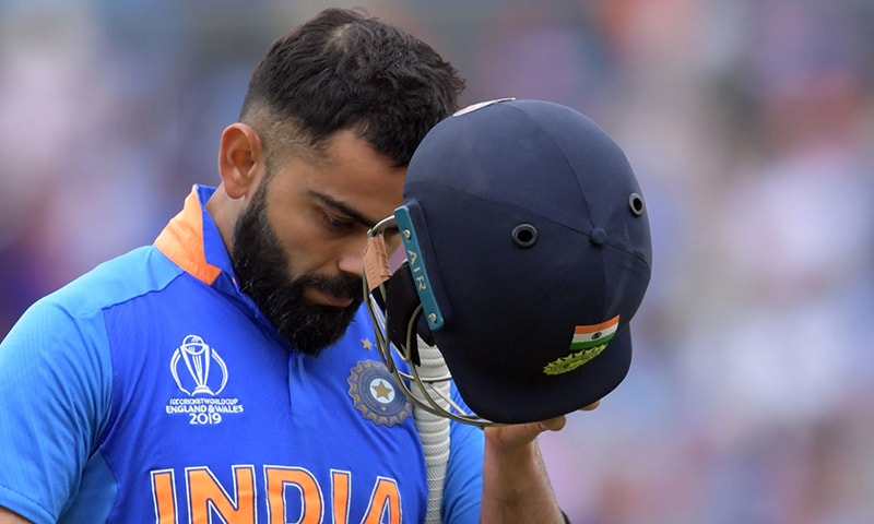 India's captain Virat Kohli leaves the pitch after losing his wicket for 1 run during the 2019 Cricket World Cup first semi-final between New Zealand and India at Old Trafford in Manchester, northwest England, on July 10. — AFP