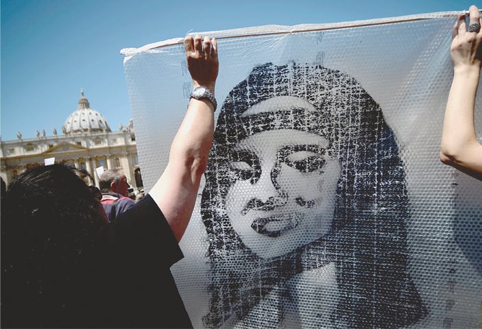 IN this file photo taken on May 27, 2012, demonstrators hold a poster of Emanuela Orlandi during Pope Benedict XVI’s prayer in St. Peter’s Square. The Vatican has decided to open an internal probe into the case of Emanuela Orlandi, a teenager who disappeared in 1983 in one of Italy’s darkest mysteries.—AFP