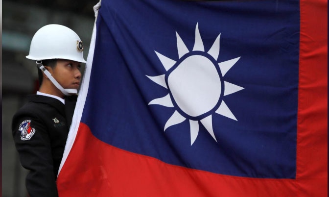 A military honour guard holds a Taiwanese national flag as he attending flag-raising ceremony at Chiang Kai-shek Memorial Hall, in Taipei, Taiwan March 16, 2018. &mdash; Reuters/File