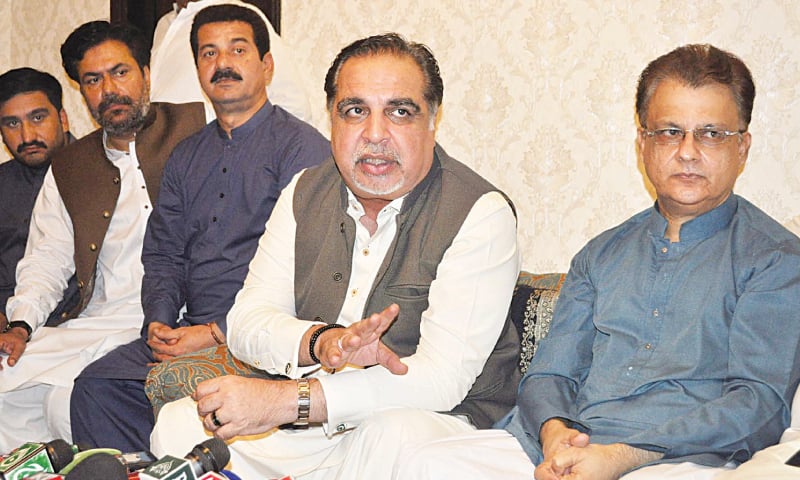 GOVERNOR Imran Ismail speaks to the media at the residence of Ayaz Latif Palijo (extreme right) in Hyderabad on Saturday.—Dawn