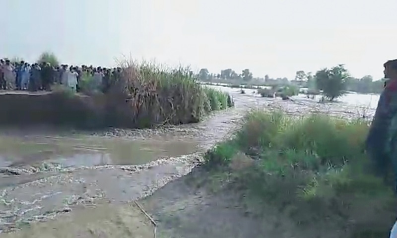 VILLAGERS look on helplessly as water gushes through the breach towards their homes and farmland.&mdash;Dawn
