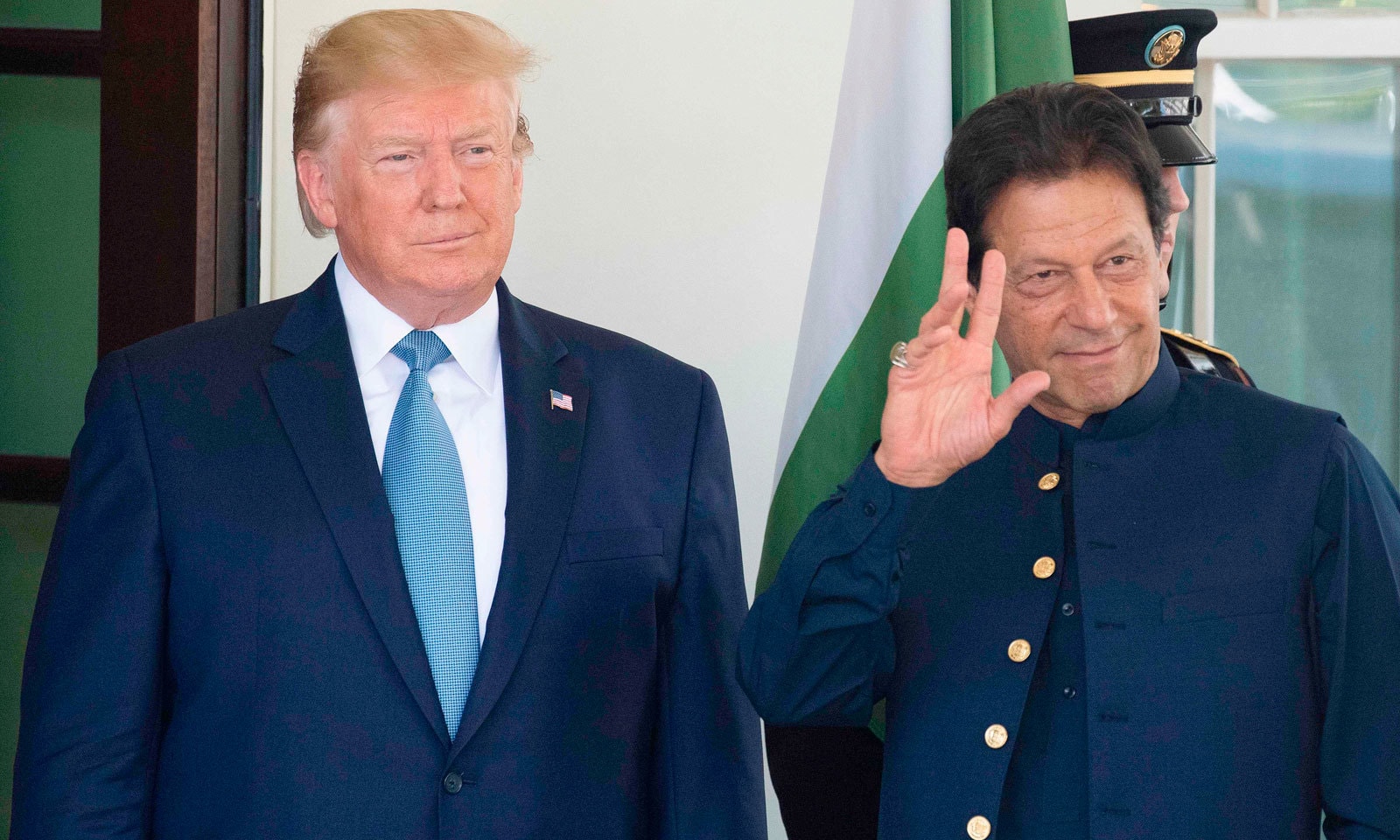 وزیر اعظم عمران خان وائٹ ہاؤس کے باہر کھڑے افراد کو ہاتھ ہلا کر جواب دے رہے ہیں— فوٹو: اے ایف پی