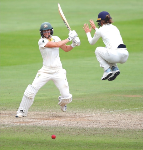 TAUNTON: Australia’s Ellyse Perry drives as England’s Amy Jones takes an evasive action during the Women’s Ashes Test at the Coopers Associates County Ground.—Reuters