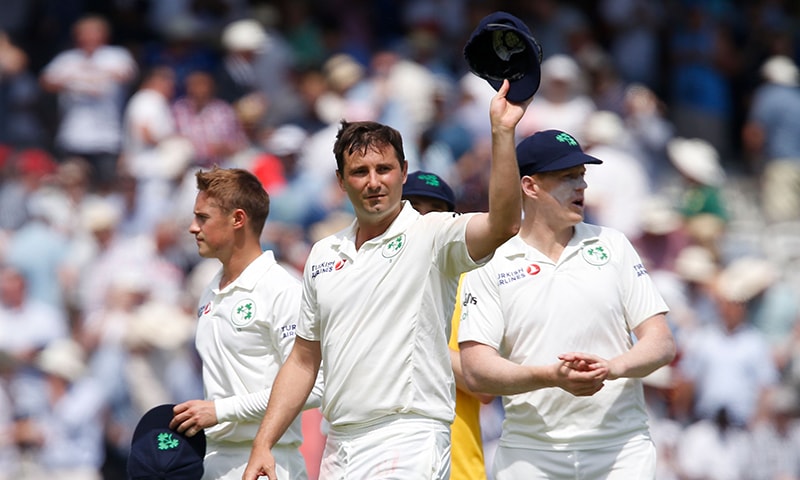 Ireland's Tim Murtagh walks off the field after taking 5 wickets and leaving England to bowl on the first day of the first cricket Test match between England and Ireland at Lord's. &mdash; AFP