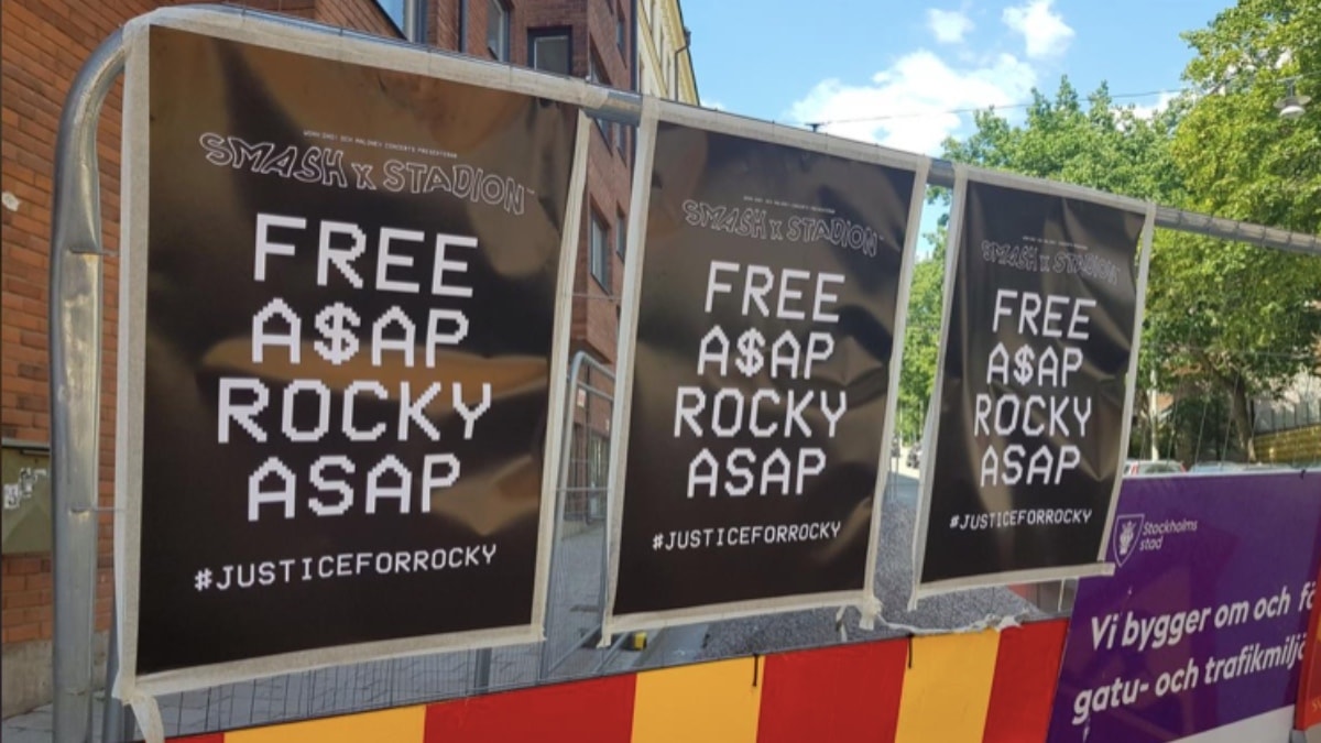 Free Asap Rocky posters line the wall across from the prison the rapper's being held in