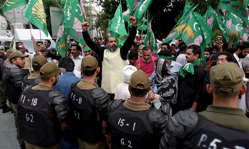 Supporters of PML-N chant slogans as police officers block the road during a countrywide protest called "Black Day" against the government of Prime Minister Imran Khan, in Lahore, July 25. — Reuters