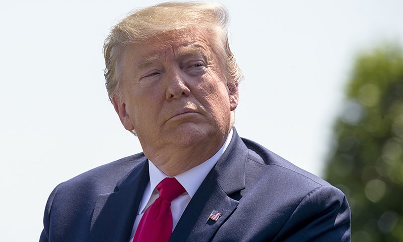 President Donald Trump is seated during a full honors welcoming ceremony for Secretary of Defense Mark Esper at the Pentagon, Thursday, July 25. — AP