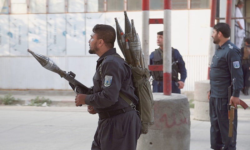 KABUL: Two security personnel take position near the site of the attack. — AP