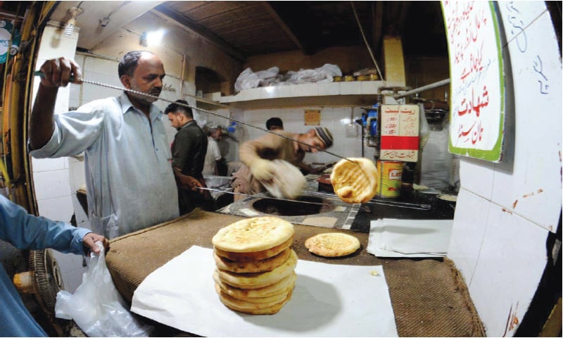 In this May 27 photo, a naanbai prepares breads at a tandoor in Rawalpindi.—APP In this May 27 photo, a naanbai prepares breads at a tandoor in Rawalpindi.—APP
