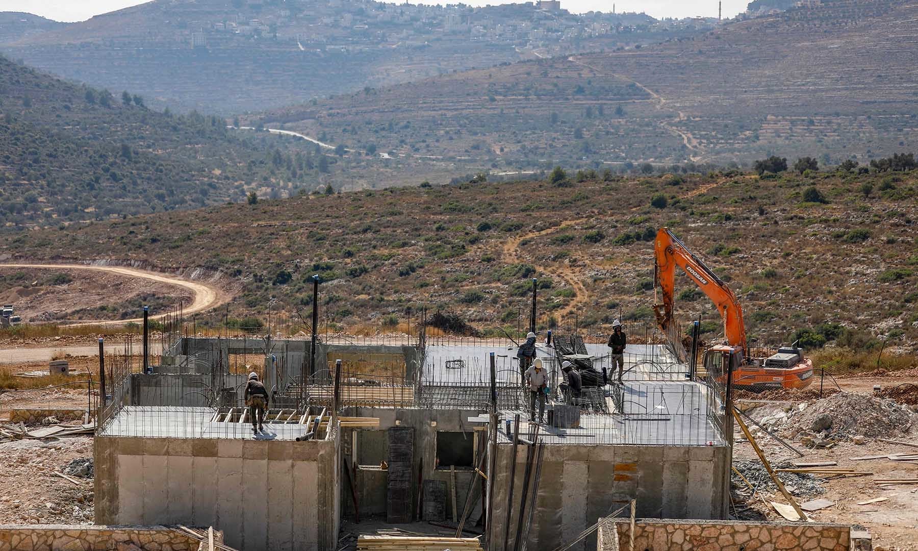 Palestinian labourers work at a construction site in the Israeli settlement of Kerem Reim in the occupied West Bank on July 31. — AFP Palestinian labourers work at a construction site in the Israeli settlement of Kerem Reim in the occupied West Bank on July 31. — AFP