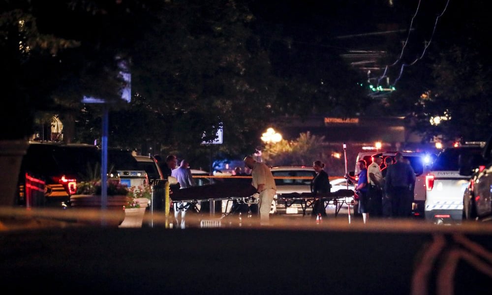 Bodies are removed from at the scene of a mass shooting on Sunday in Dayton, Ohio. — AP