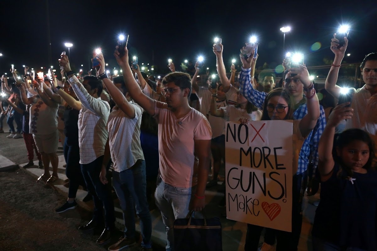 Mourners take part in a vigil near the border fence between Mexico and the US after a mass shooting at a Walmart store in El Paso on August 3. — Reuters