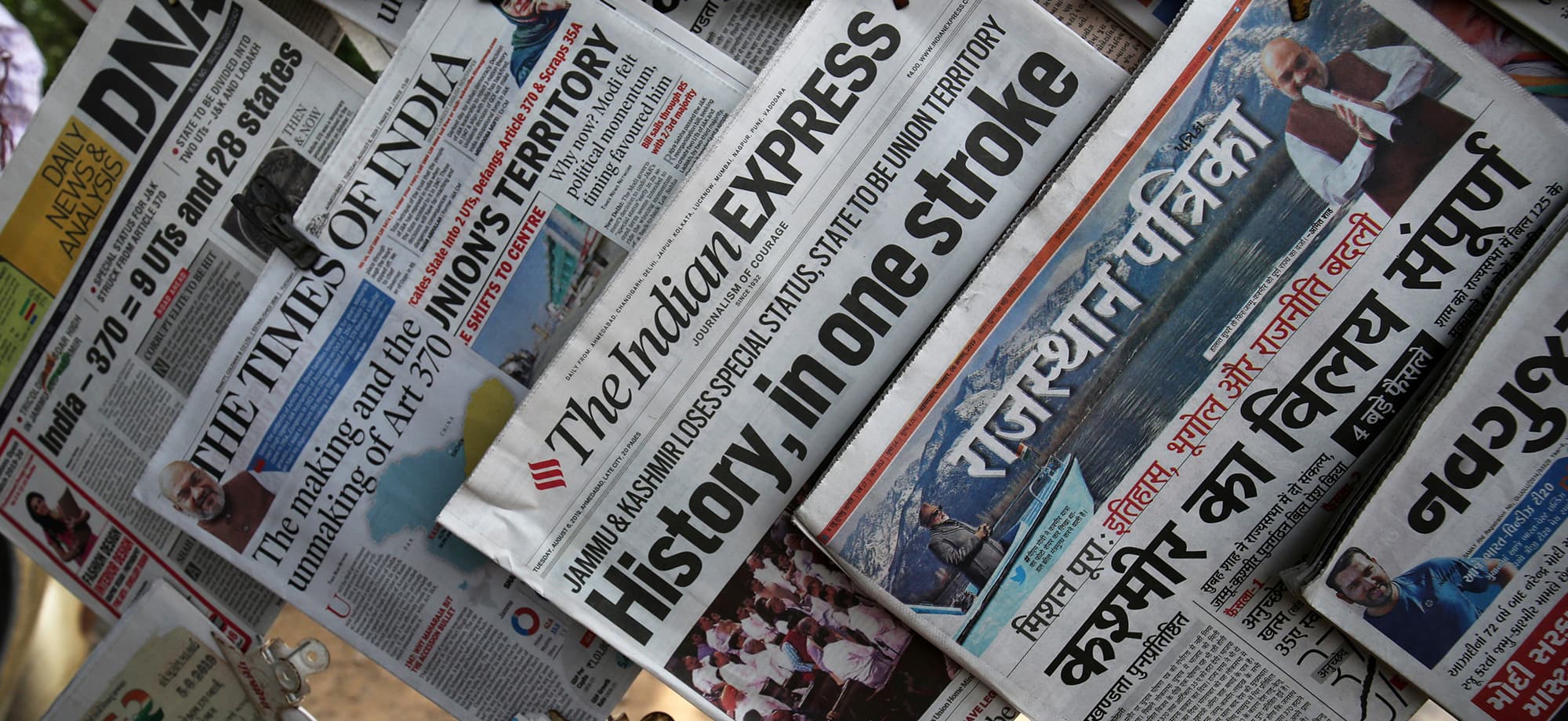 Newspapers, with headlines about Prime Minister Narendra Modi's decision to revoke special status for the disputed Kashmir region, are displayed for sale at a pavement in Ahmedabad, India, August 6, 2019. REUTERS/Amit Dave