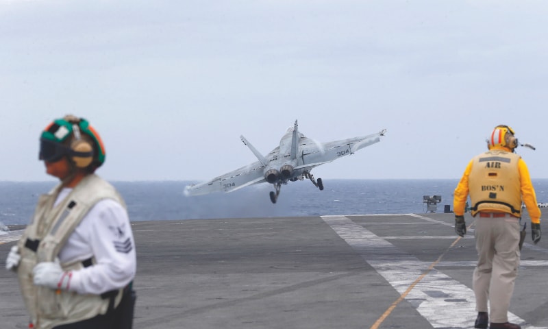 A US fighter jet takes off from the aircraft carrier, USS Ronald Reagan,  for patrol in international waters off South China Sea on Tuesday. — AP