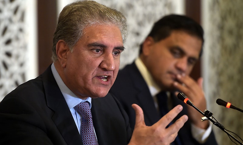 Foreign Minister Shah Mehmood Qureshi (L) speaks during a press conference at the Foreign Ministry in Islamabad on August 8. — AFP