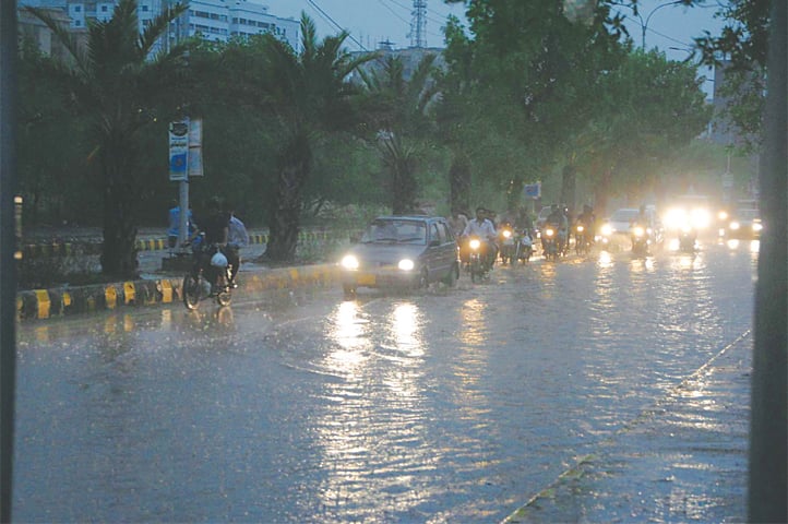 A MAIN thoroughfare in Hyderabad inundated in rainwater after several long spells of showers on Saturday.—Dawn