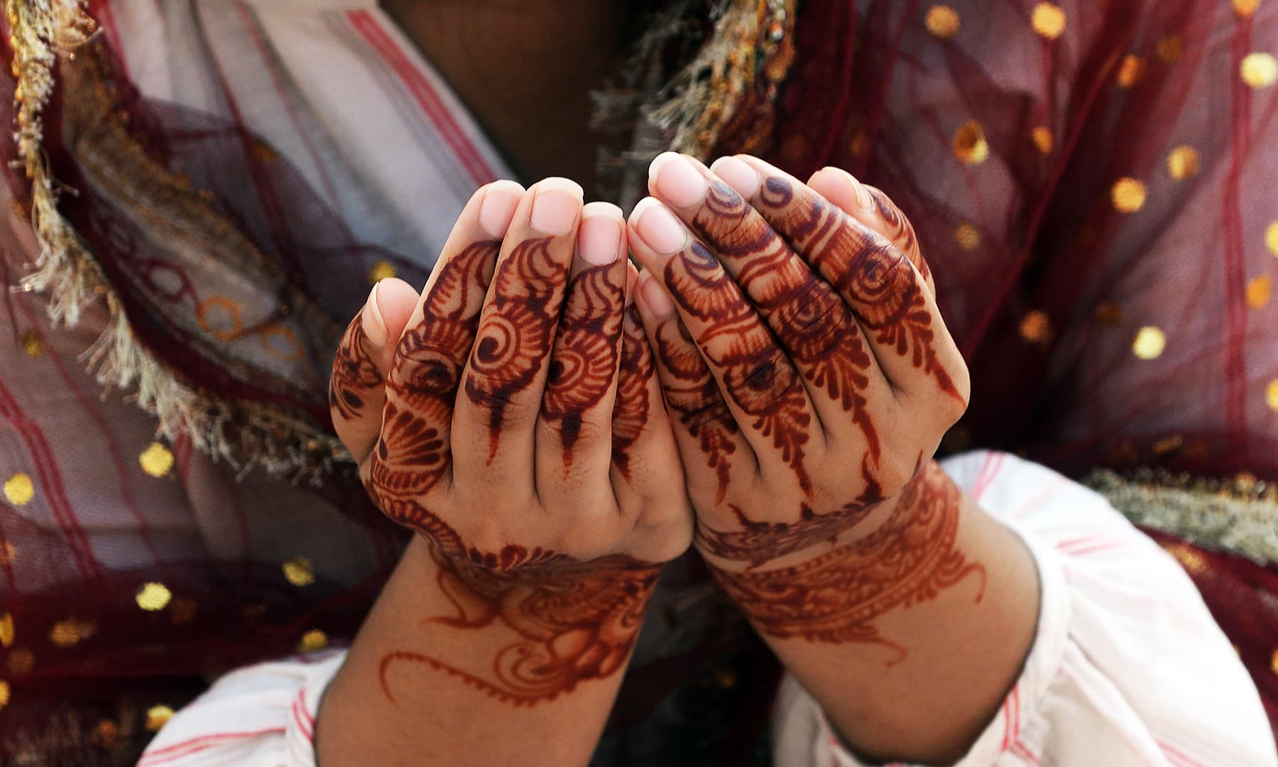 A woman offers pray during Eidul Azha prayers at the Badshahi Mosque in Lahore on Monday. &mdash; AFP