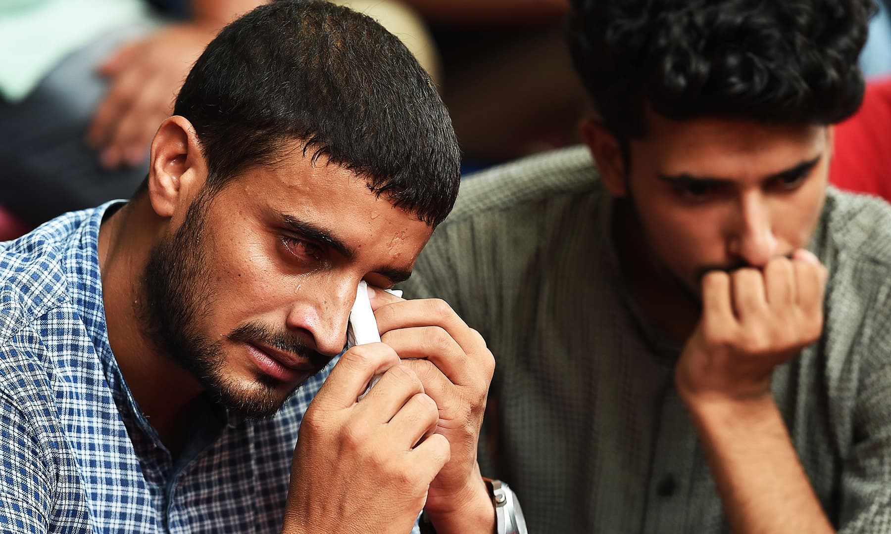 Kashmiri youth react while listening during a gathering to celebrate Eid al-Adha in New Delhi on Monday. (Photo by Prakash SINGH / AFP) &mdash; AFP or licensors
