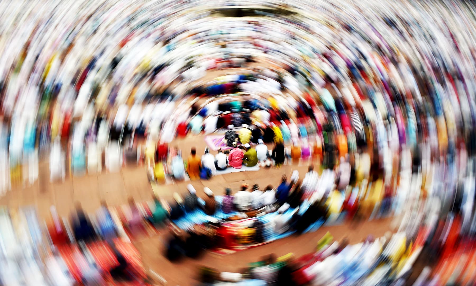 Indian Muslim devotees sit after offering prayers during Eidul Azha at Jama Masjid in New Delhi on Monday. &mdash; AFP