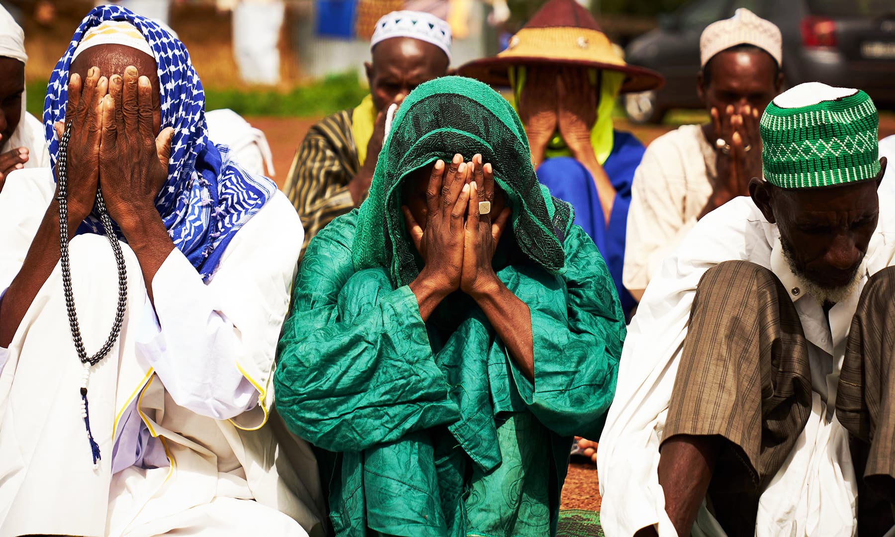 Fulani displaced men cover their faces as they pray during the Eidul Azha in a refugee camp in Bamako on Sunday. &mdash; AFP