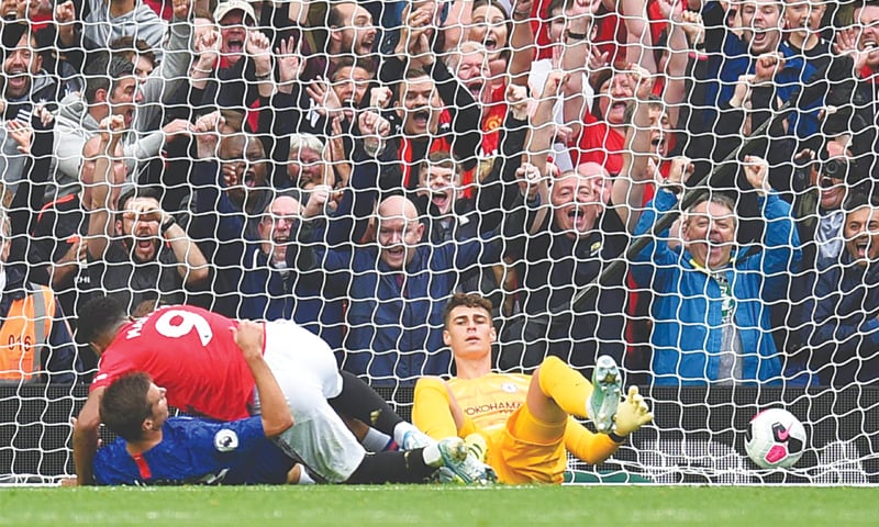 MANCHESTER: Manchester United&rsquo;s Marcos Rashford (C) falls down after socring past Chelsea goalkeeper Kepa Arrizabalaga during their Premier League match at Old Trafford.&mdash;AFP