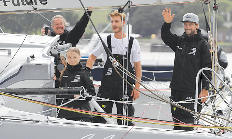 Plymouth (UK): Swedish teenage climate activist Greta Thunberg and crew members Pierre Casiraghi and Boris Herrmann wave from their boat as she starts her trans-Atlantic boat trip to New York.—Reuters